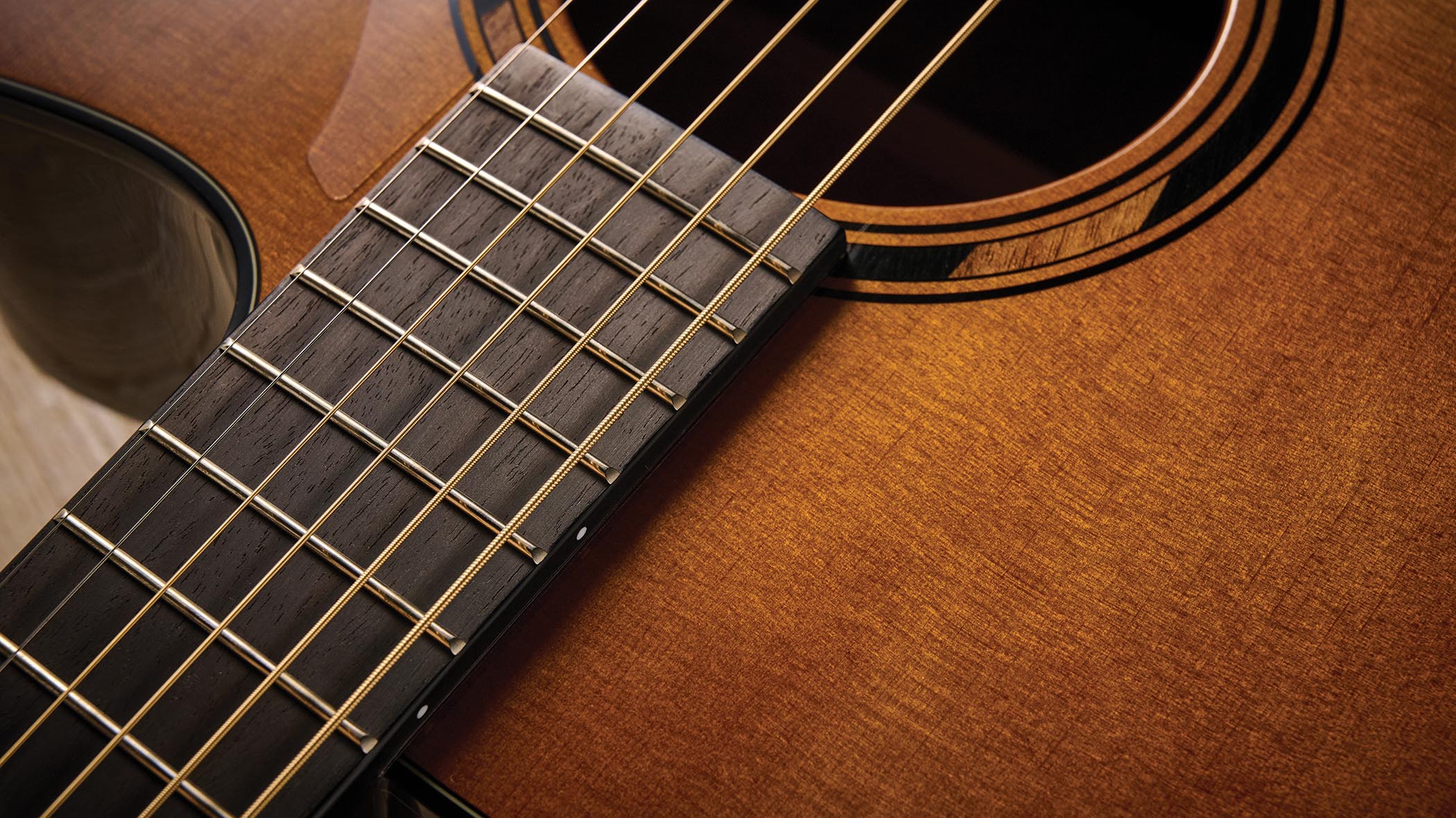 The Yamaha TransAcoustic TAG3 C is a cutaway acoustic guitar with a sandburst finished, photographed in closeup