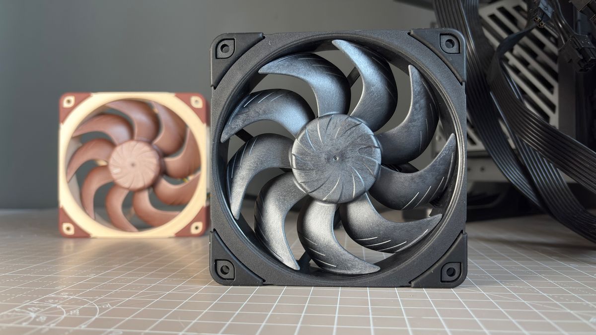 Various PC fans on a table with testing equipment for a round of batch tests.