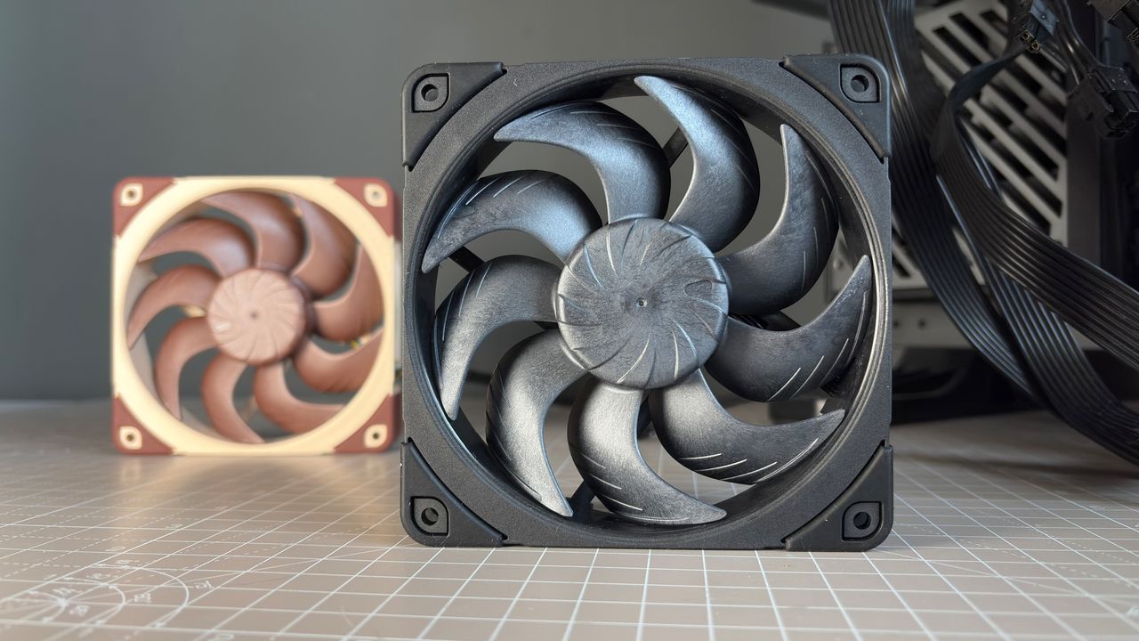Various PC fans on a table with testing equipment for a round of batch tests.