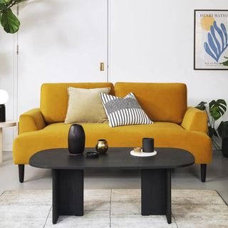 Mustard colour sofa in a white living room