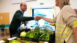 Prince William shaking hands with a member of the public while wearing Garmin Forerunner 245 watch