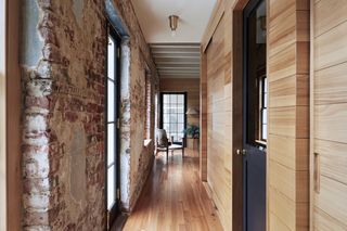 hallway with brick and wooden walls