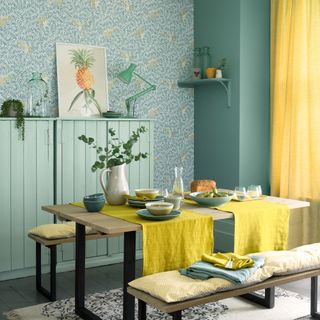 dining room with wallpaper and potted plant on dining table