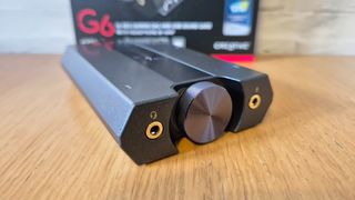 The Creative Sound BlasterX G6 USB sound card on a wooden surface