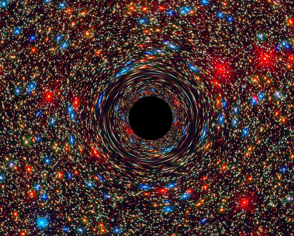 Here, a computer-simulated image of a supermassive black hole at the core of a galaxy, with the black region at the center representing the event horizon.