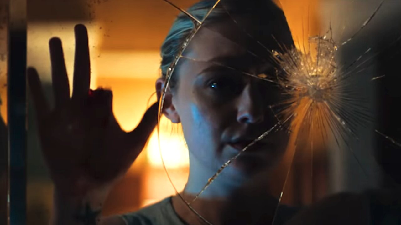 Dakota Fanning in front of cracked mirror with missing finger