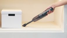 A Brigii Cordless Handheld Vacuum cleaning a shelf