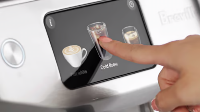 Person selecting cold brew coffee using Breville Oracle Jet touchscreen