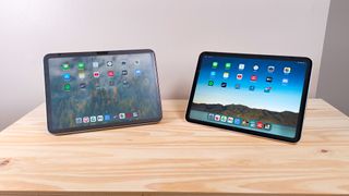The iPad 10 and iPad 11 propped up side by side on a wood table