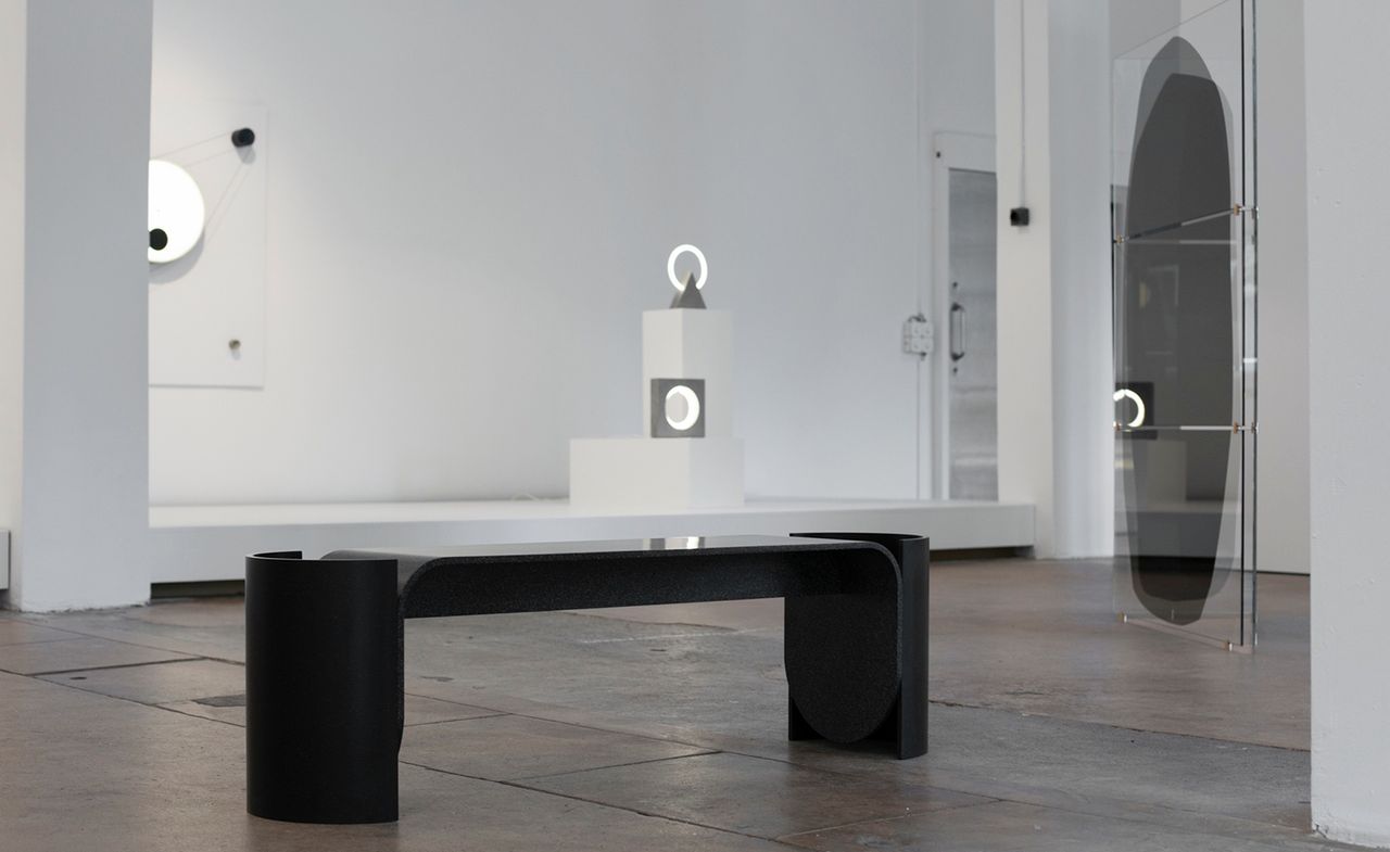 A black bench is displayed at the Roehrs &amp; Boetsch gallery.