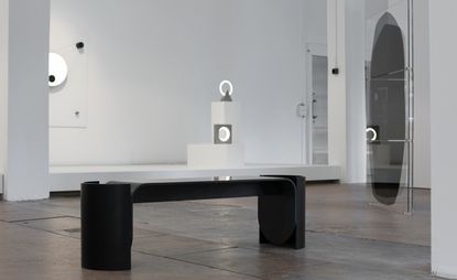 A black bench is displayed at the Roehrs & Boetsch gallery.