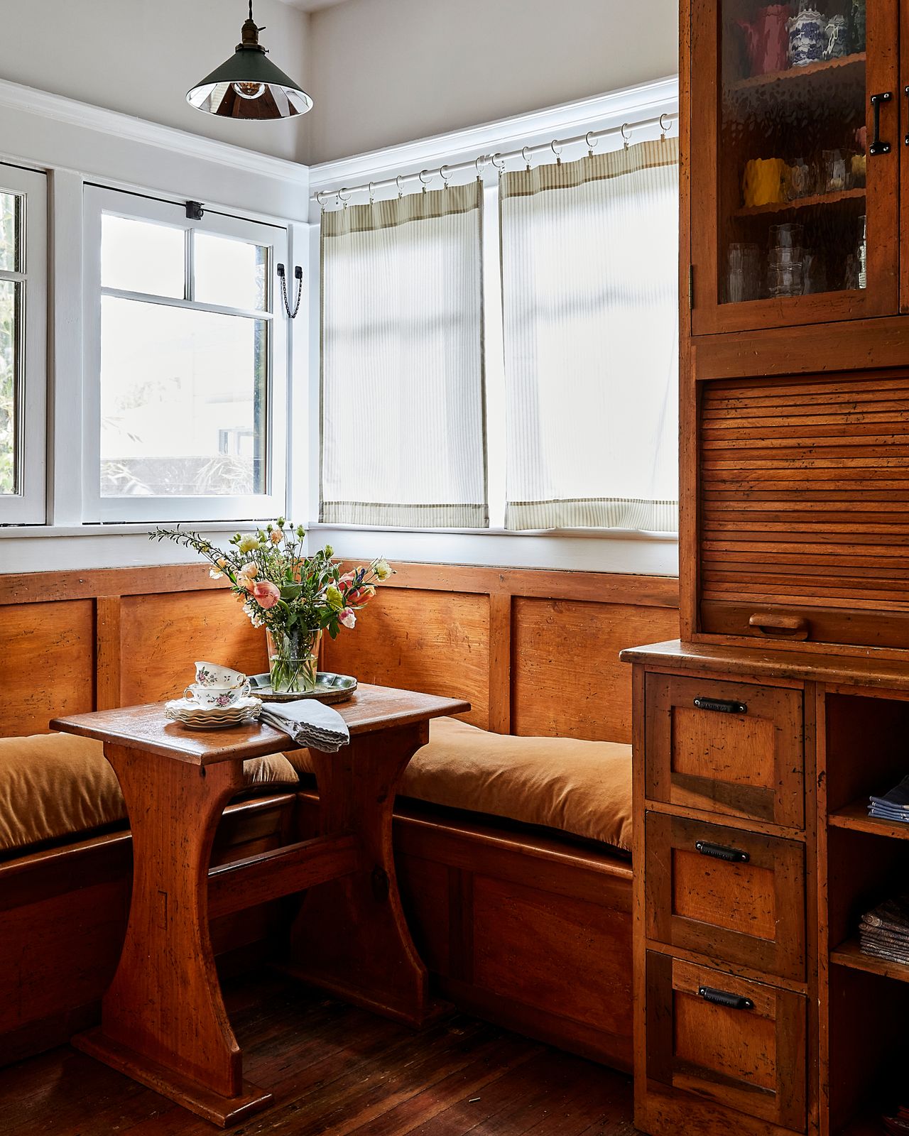 built in wooden bench in wooden kitchen