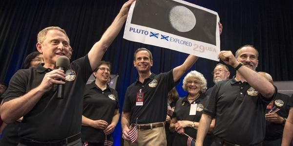 NASA crew members celebrate New Horizons confirming it survived its flyby.