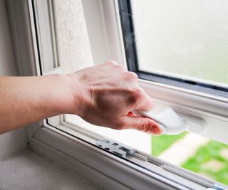 hand opening white upvc window