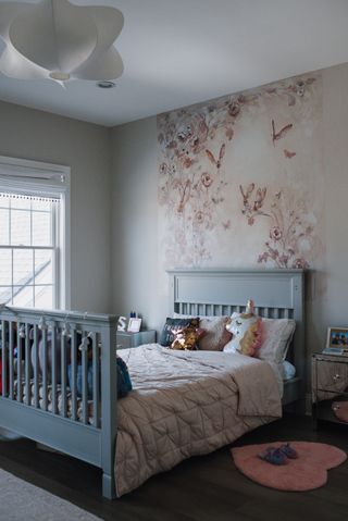 Child's room with blue bed patterned wallcovering