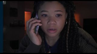 A still from the movie Missing in which Storm Reid as June Allen is holding a phone and looking frightened