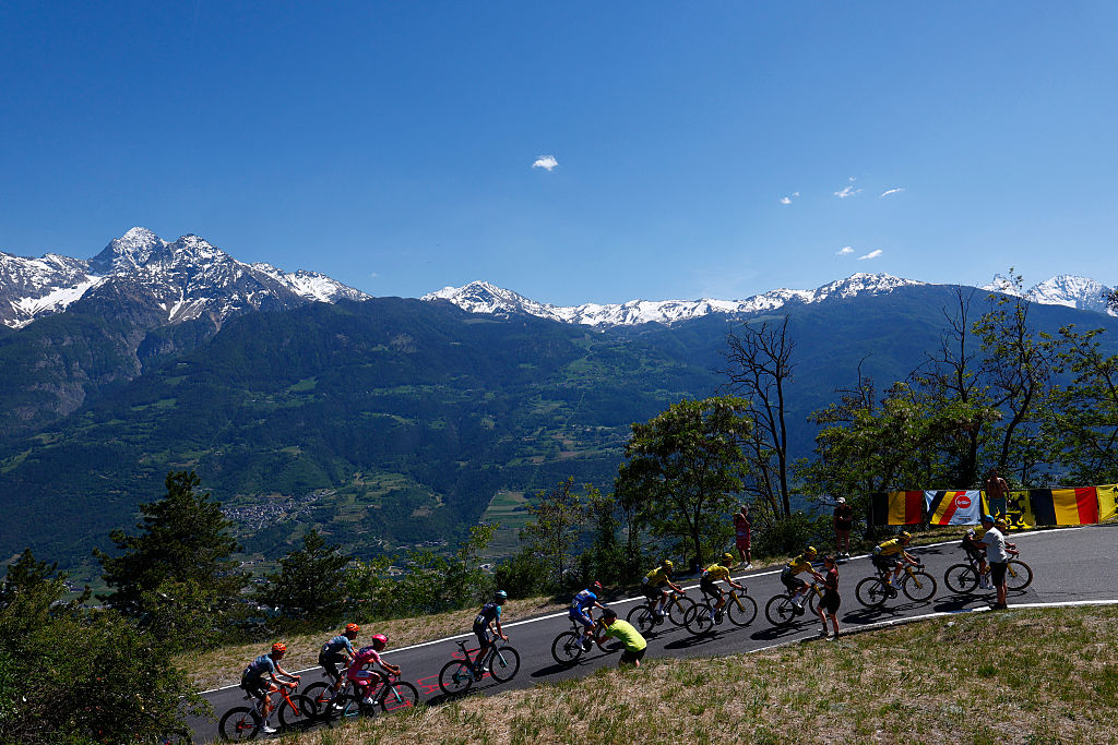 The pack rides during the 14th stage of the Giro d'Italia 2026 - Tour of Italy cycling race between Aosta and Pila (Gressan), Italy, on May 23, 2026. (Photo by Luca Bettini / AFP)