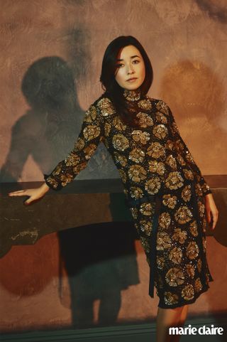 Actress Maya Erskine in a black and gold sparkly dress