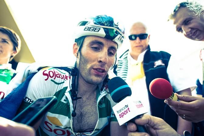 Jonathan Hivert (Sojasun), the final rider to cross the finish line on the Mont Ventoux summit, talks to the media