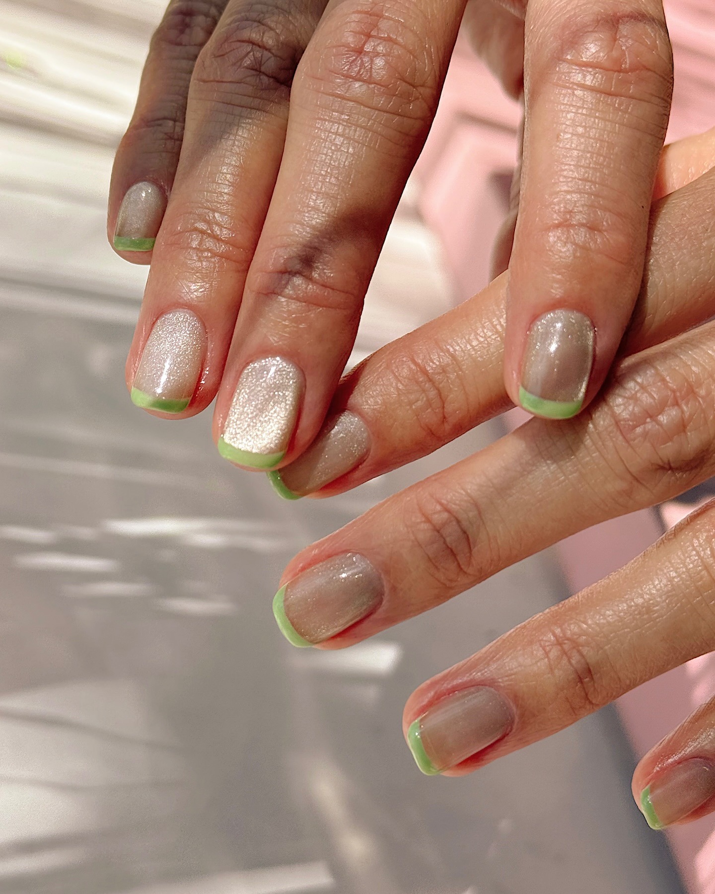 Magnetic French tips with matcha green accents.