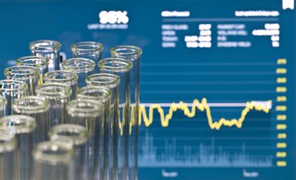 Biotech investing illustration - test tubes overlaid on stock chart