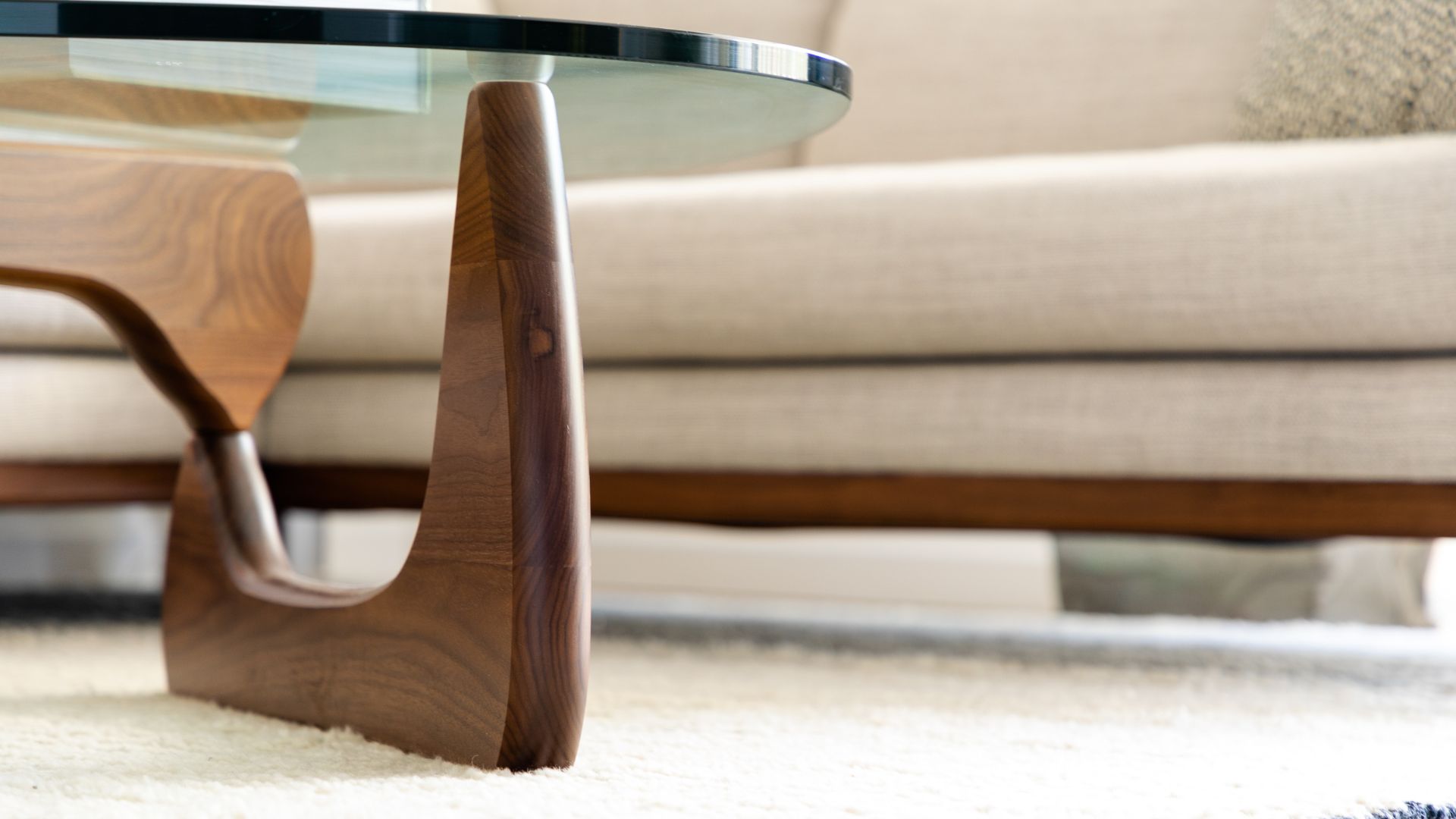 picture of midcentury style glass and wood coffee table in living room