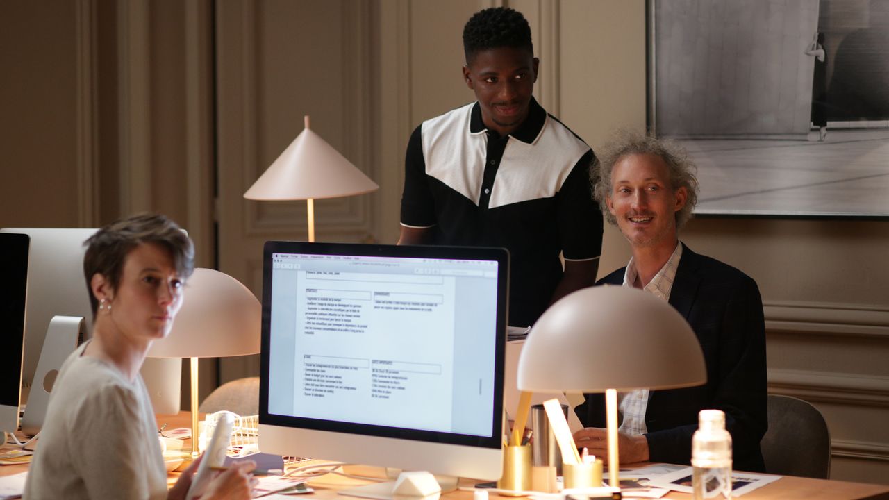 Bruno Gouery as Julien, right, and Samuel Arnold as Luke, center, in Emily in Paris on Netflix.