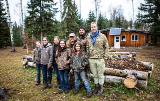 Ben Fogle: New Lives in the Wild. Shows Rose, Jeff, Sarah, Abigail, Julia, Chrstina, Keziah Burkinshaw with Ben outside house