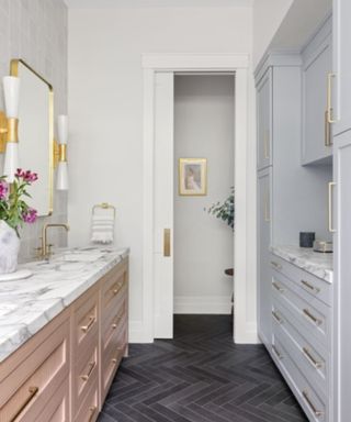 modern bathroom with gray cabinets, white walls and marble countertops