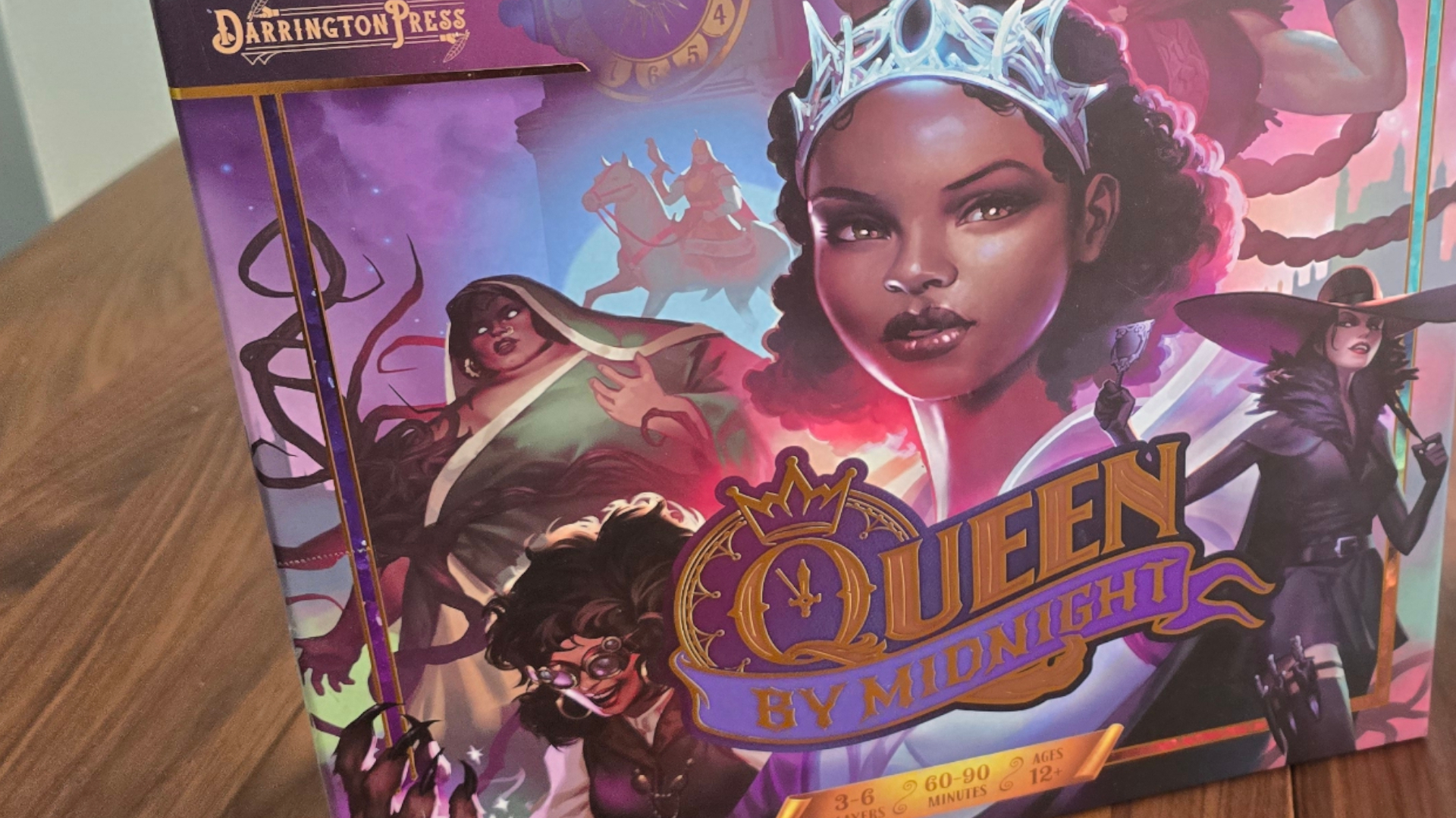 Queen by Midnight box on a wooden table