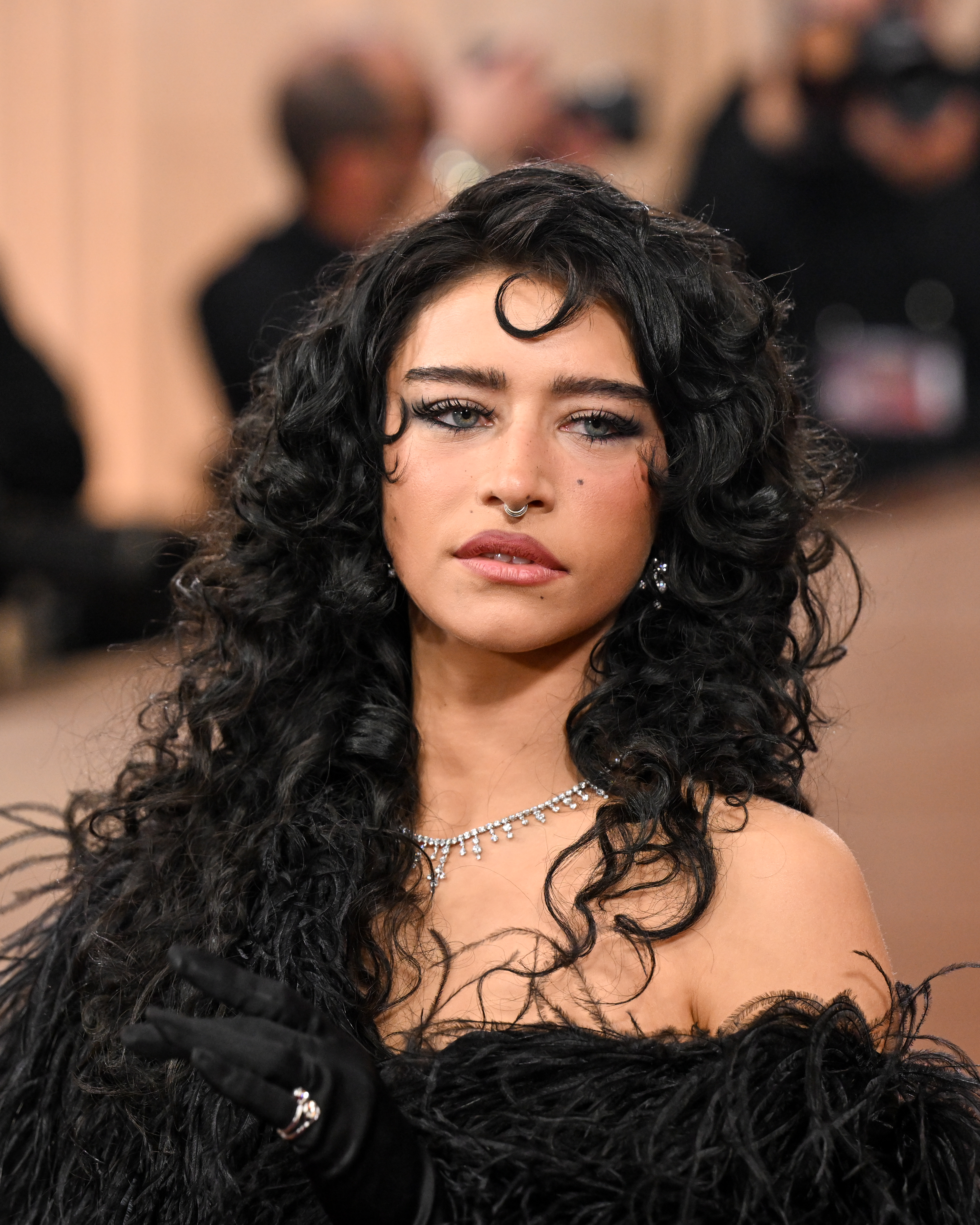 a white woman with curly, dark hair on the red carpet