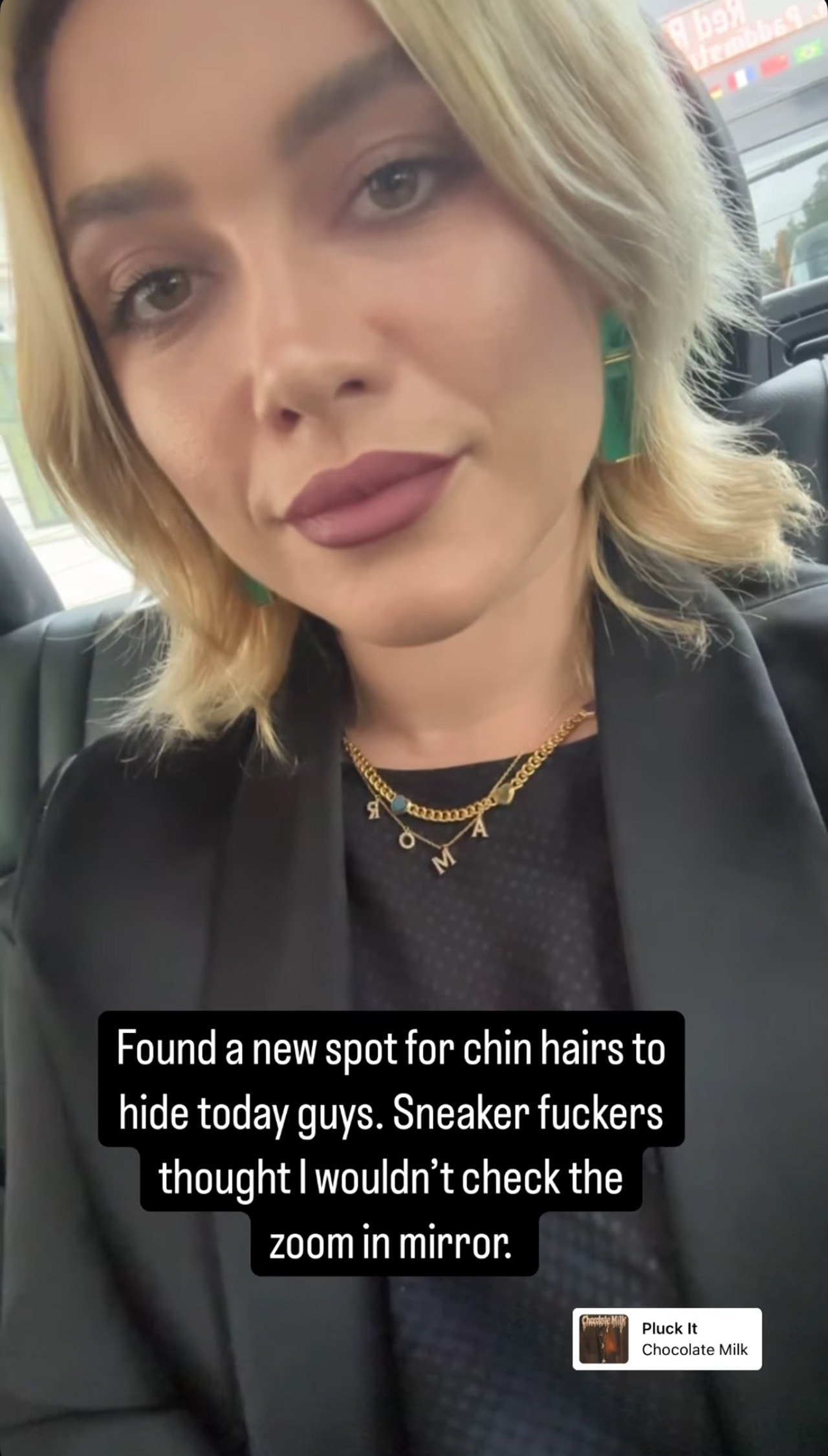 Florence Pugh wears lipstick and a black suit while telling her audience about chin hair issues.