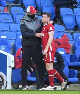 Liverpool’s James Milner, right, is consoled by manager Jurgen Klopp as he is substituted with an injury