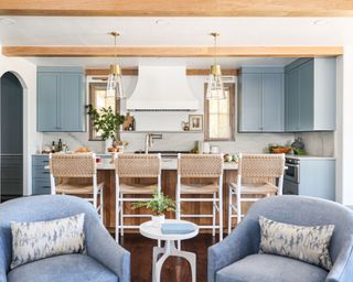 blue kitchen with seating island and two blue armchairs