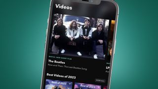 A phone on a green background showing the Tidal app