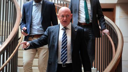 Sen. Mark Kelly (D-Ariz.) leaves breifing in the Capitol.