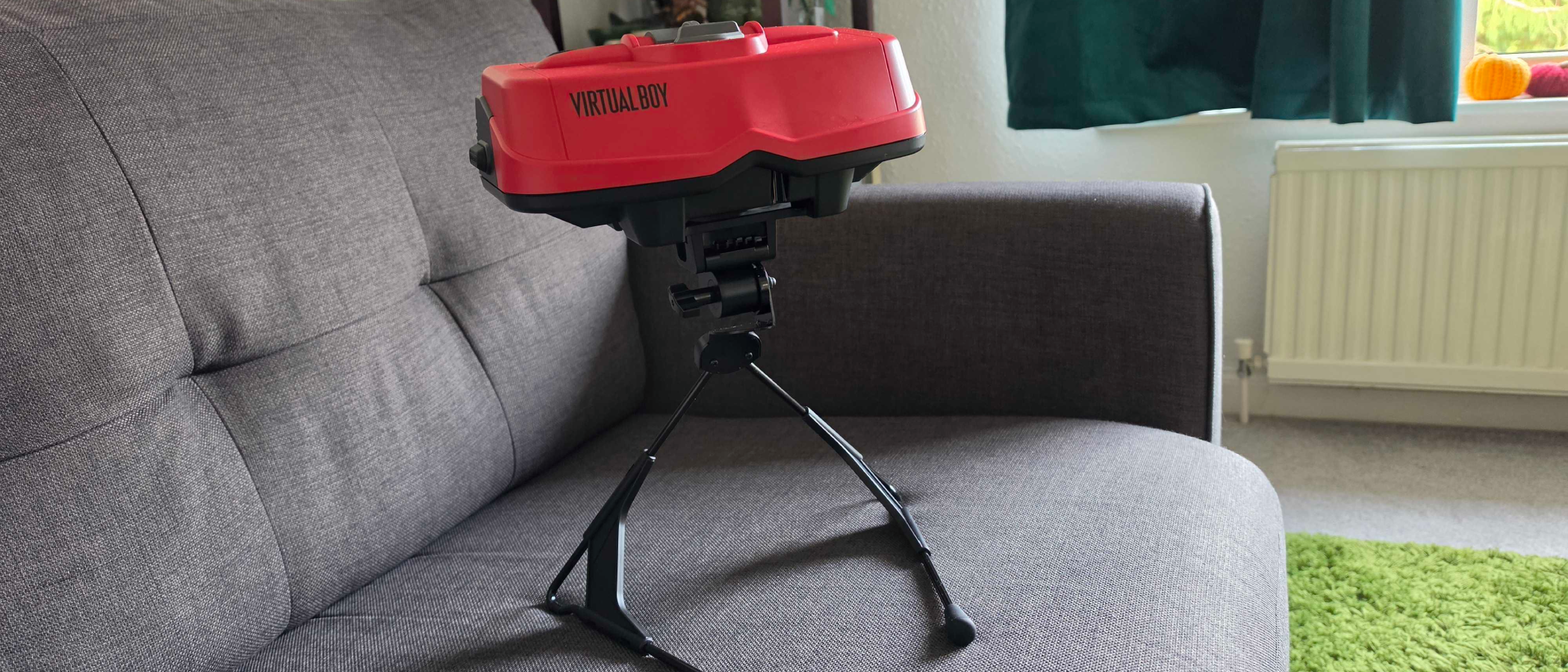 The Virtual Boy on a gray sofa