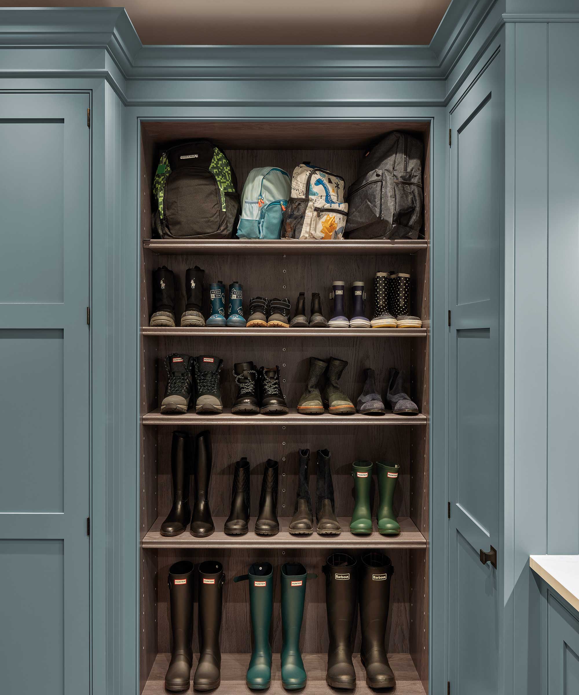 blue boot room with open shelving for boots and shoes