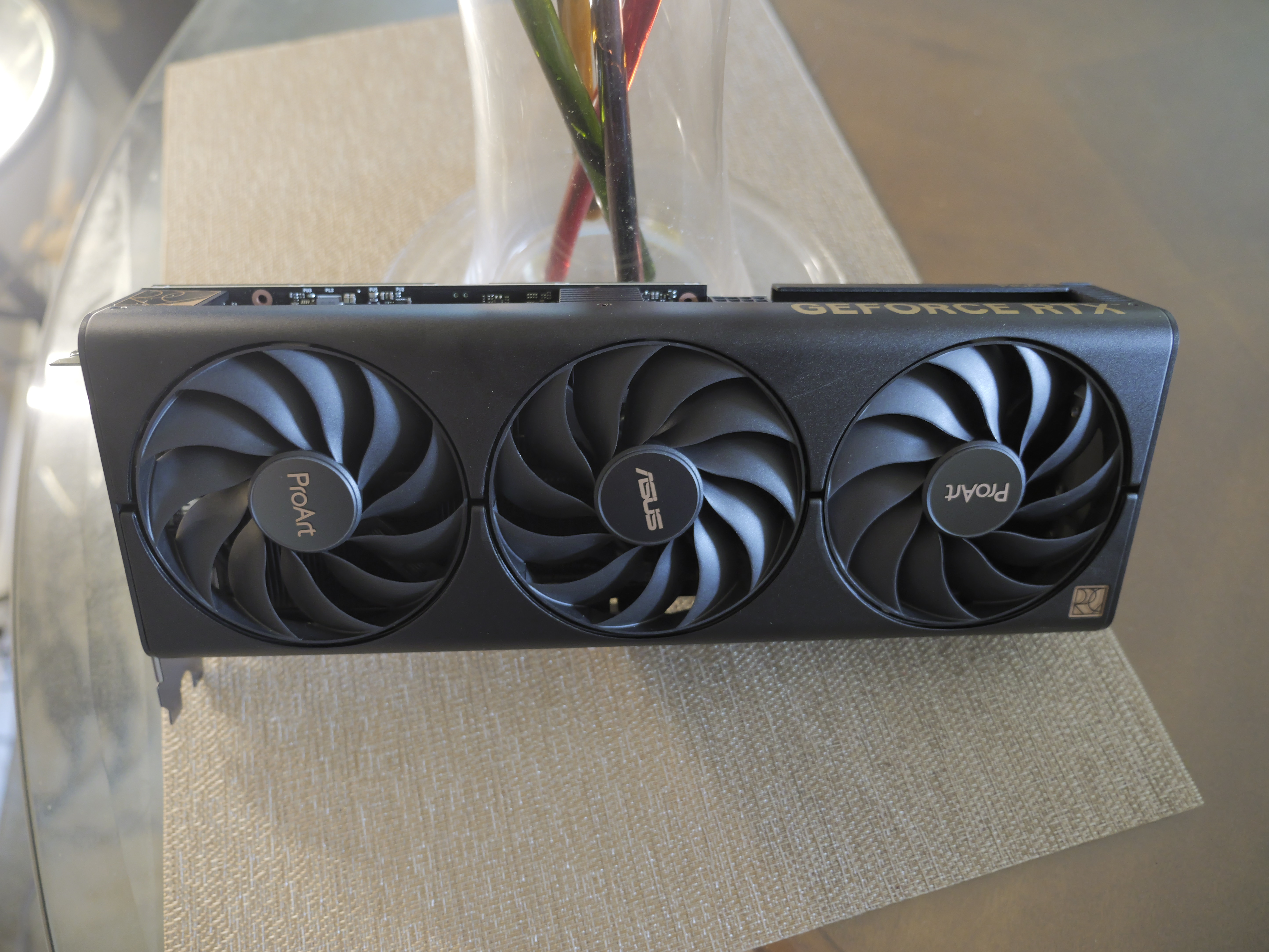 An ASUS ProArt RTX 4060 Ti graphics card sitting on a desk