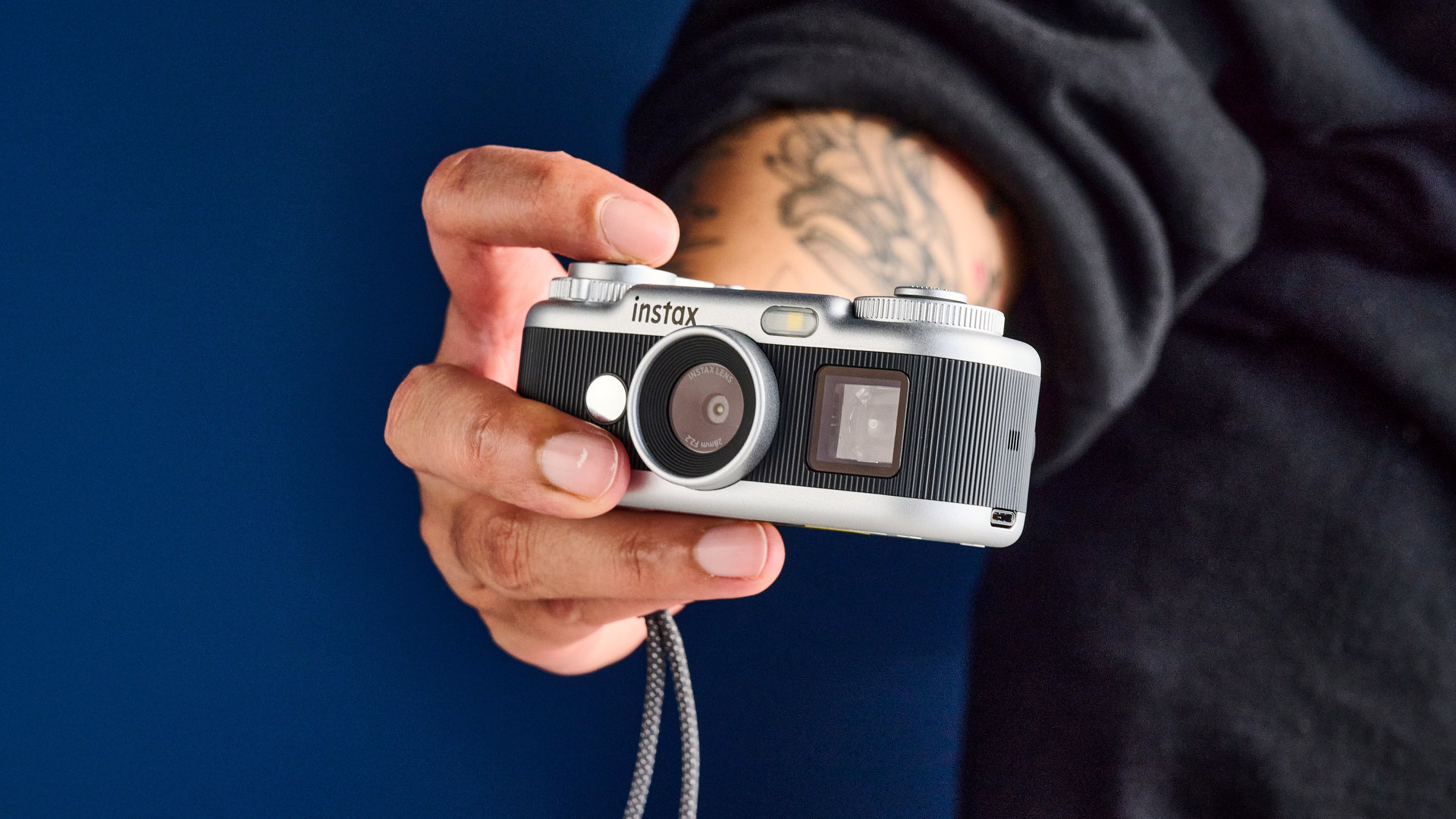 A black and silver Fujifilm Instax Pal 2 digital camera