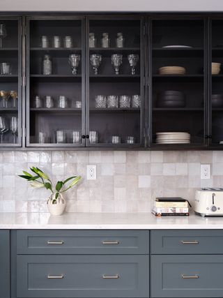 A kitchen with blue-green cabinet paint