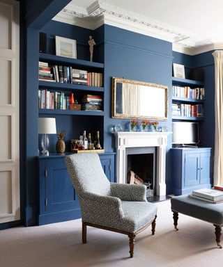 living room with dark blue walls and fireplace