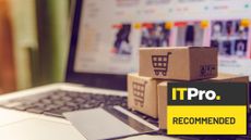 laptop on ecommerce website with ecommerce boxes and credit card on the keyboard