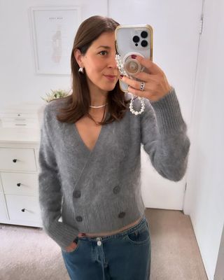 woman wearing still here NYC jeans and grey sweater