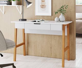 A wooden and metallic desk against a wooden wall.