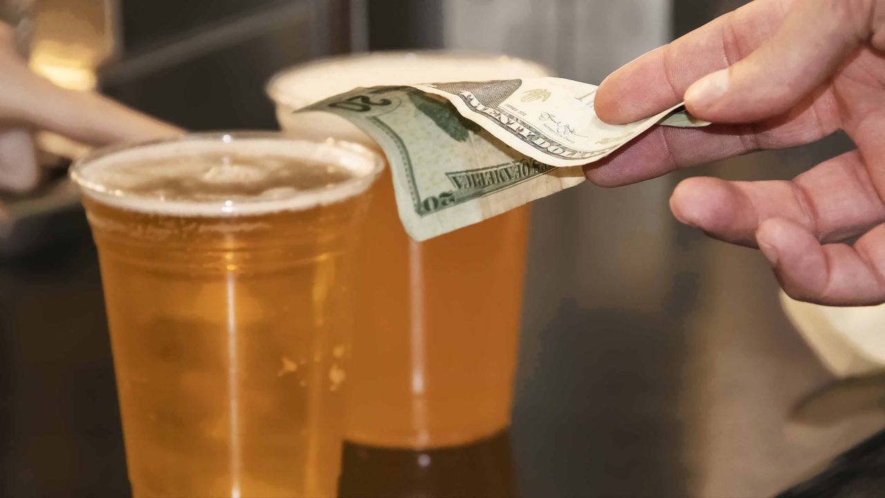 picture of person paying for beer