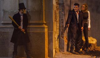 An Abraham Lincoln purger waits for Frank Grillo and Elizabeth Mitchell in The Purge: Election Year.