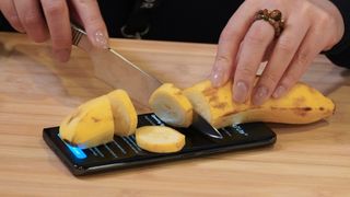 Cutting a banana on a Magic 7 Lite phone.