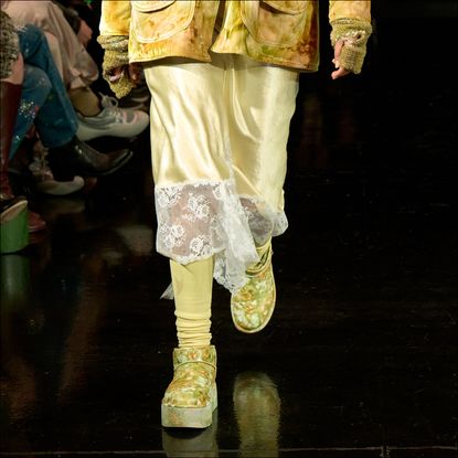 a model walks the collina strada runway wearing floral ugg boots