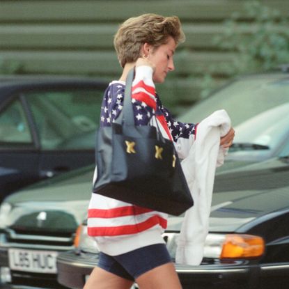 Princess Diana wearing an American flag sweatshirt and bike shorts 